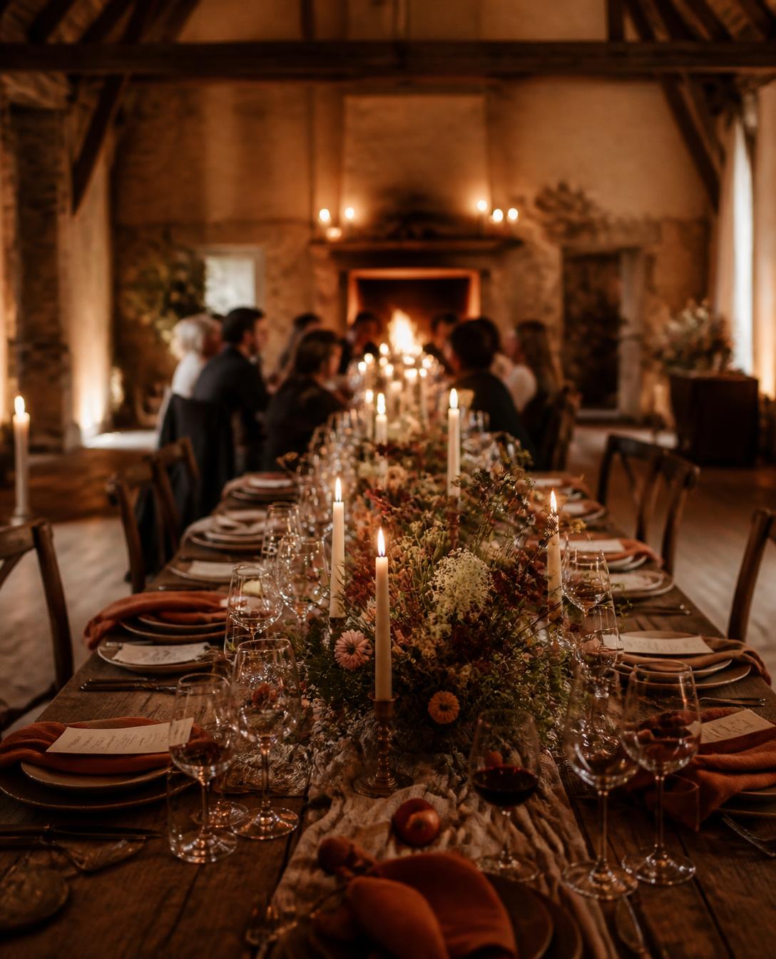Long candlelit dinner table set for an intimate gathering